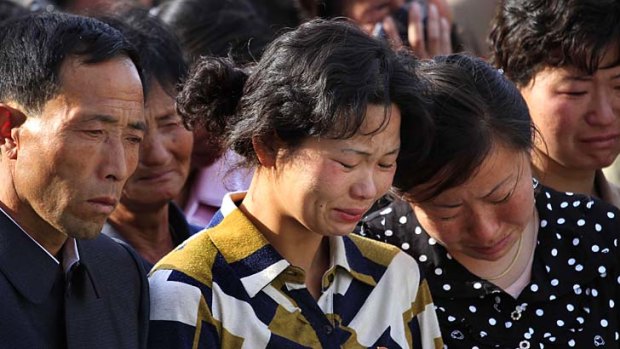 Families of victims of an accident at an apartment construction site in Pyongyang grieve during a gathering in the capital.