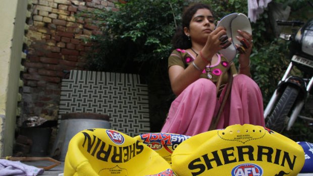 18-year-old Ruby has been stitching full-time since she was pulled out of school at 14. She stitches six days a week, for between six an eight hours a day. To stitch a Sherrin Auskick ball takes an hour, and she is paid seven Rupees, about 12c, for every completed ball.