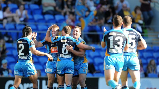 Titans players celebrate a try in their win against the Penrith Panthers at Skilled Park.
