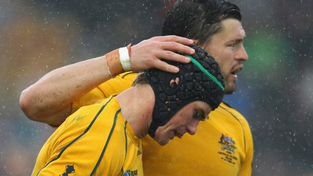 Berrick Barnes, left, is congratulated after scoring a try for the Wallabies against Russia.