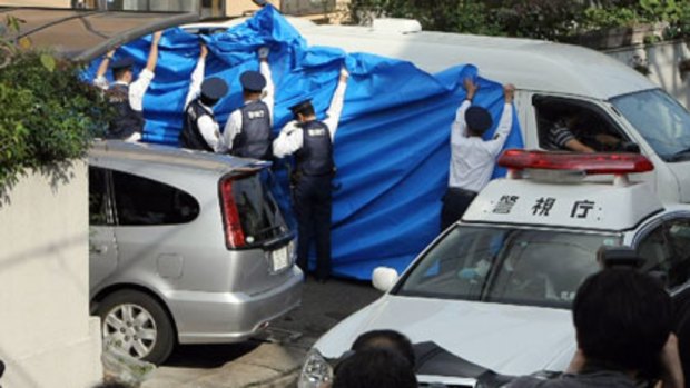 Found dead . . . The body of former Japanese finance minister Shoichi Nakagawa is taken away for an autopsy, after he was found dead in his home.
