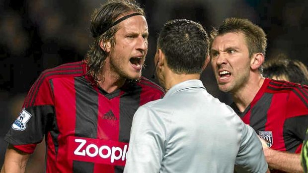 Angry: West Bromwich Albion's Jonas Olsson, left, and Gareth McAuley argue with referee Andre Marriner after a controversial penalty was awarded to Chelsea.