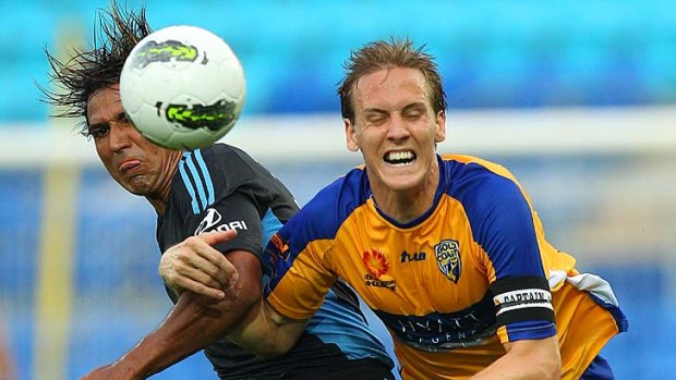 Nick Carle of Sydney FC and Michael Thwaite of United contest the ball.