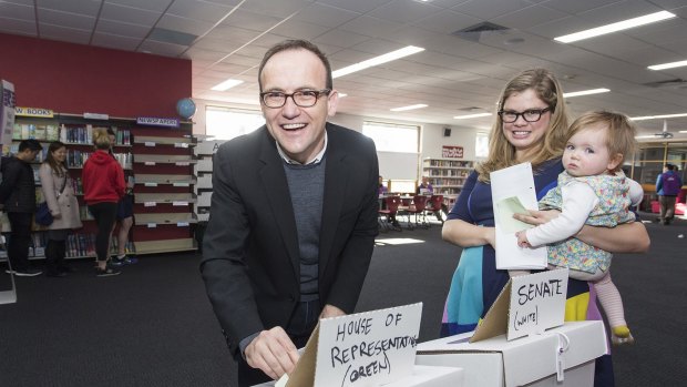 Adam Bandt, who has retained his seat of Melbourne, casting his vote on Saturday with his wife Claudia Perkins and daughter Wren. 