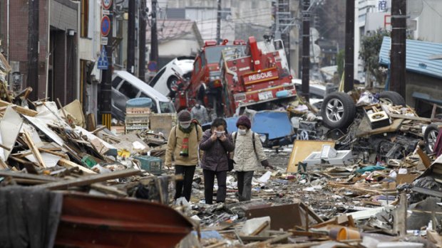 People look through the ruins of Kamaishi, part of Japan devastated by the March's earthquake and tsunami.