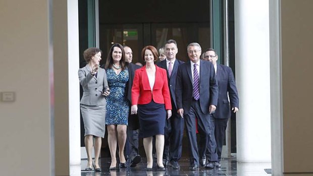 Julia Gillard, shown here with her supporters, has retained the prime ministership.