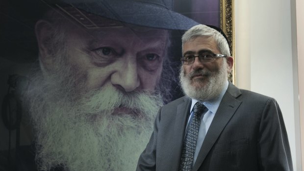 'Diamond Joe' Gutnick in front of a painting of Rabbi Menachem Mendel Schneerson, the last Lubavitcher Rebbe.