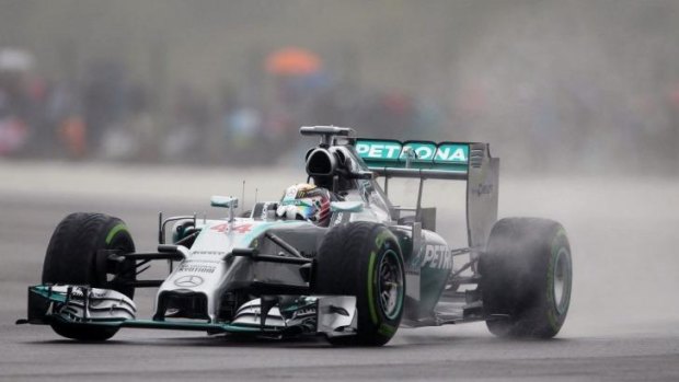 Spray day: Lewis Hamilton speeds his Mercedes through the wet during practice for the British Formula One Grand Prix.