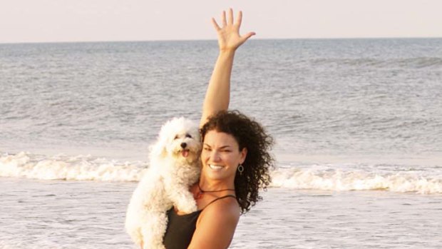 Doga instructor Suzi Teitelman and dog Roxy  in a warrior pose at Ponte Vedra Beach, Florida.