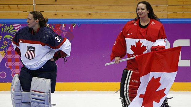 Canada's goalie Shannon Szabados (R) celebrates as Team USA's goalie Jessie Vetter looks away after Canada won the gold.