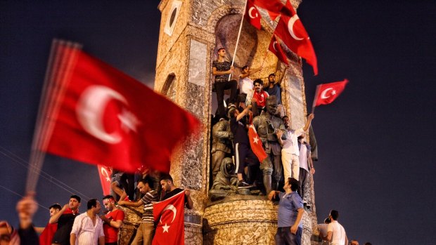 Supporters of Turkish President Recep Tayyip Erdogan wave flags after a military coup was foiled.