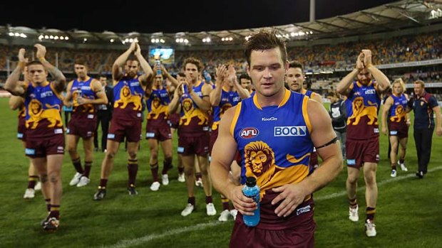 Amon Buchanan and his Lions teammates leave the field after last night's game against the Western Bulldogs.