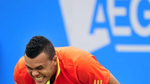 Ouch: Jo-Wilfried Tsonga grimaces after hurting a finger during his match at Queen's Club.