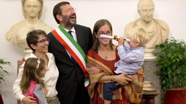Rome mayor Ignazio Marino celebrates with   Costanza Tantillo (left) and her partner Monia di Giuseppe and their children after registering their marriage in defiance of the law in Rome on Saturday.