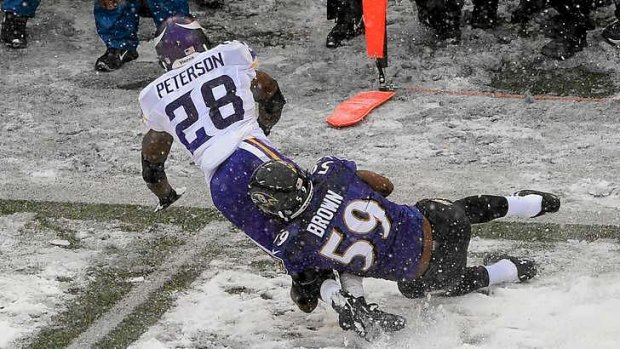 Running back Adrian Peterson of the Minnesota Vikings is tackled by inside linebacker Arthur Brown.