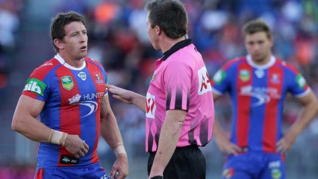 Newcastle's Kurt Gidley talks to referee Jared Maxwell following a blatant penalty conceded by Cooper Cronk of Melbourne.