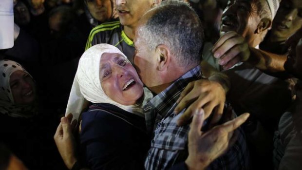 Freed Palestinian prisoner Jamil Nabi Annatsheh (right) is greeted by his mother upon his arrival in the West Bank city of Ramallah.