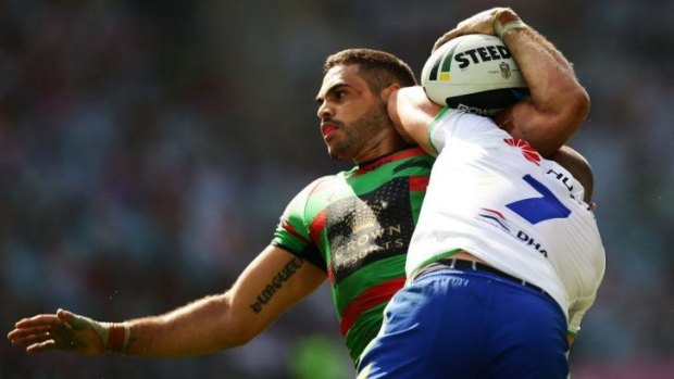 Going backwards: Souths star Greg Inglis is driven back by Terry Campese in the loss to the Raiders.