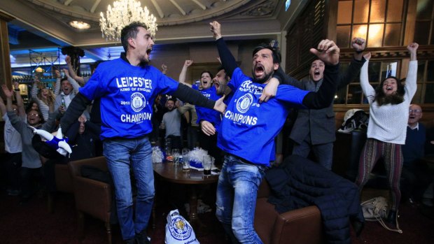 Leicester City fans celebrate in Leicester after Chelsea's Eden Hazard scores the equalising goal against Tottenham Hotspur, delivering the Foxes the Premier League championship.