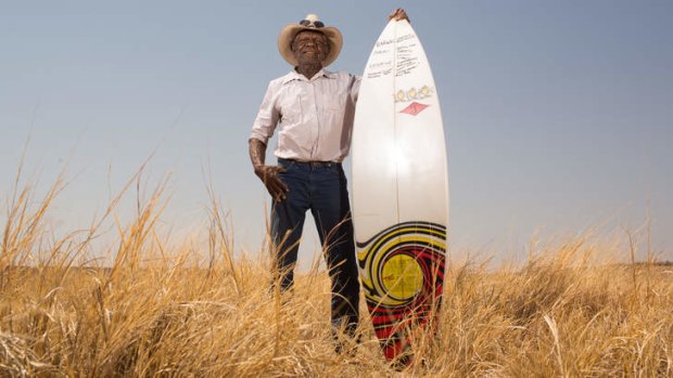 Board ructions: Jimmy Wavehill with the Recognise campaign surfboard at Wave Hill station.