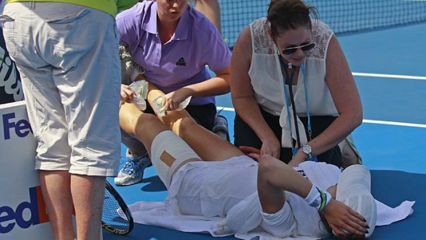 Blistering heat ... Galina Voskoboeva of Kazakhstan receives medical treatment after being affected by high temperatures.