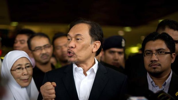 ''Politically motivated'' ... the Malaysian Opposition Leader, Anwar Ibrahim, puts his case outside court yesterday after being charged with violating a court order.