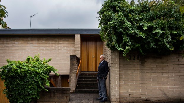Architect Neil Clerehan at the Domain Rd house he designed in South Yarra that has been heritage listed. 
