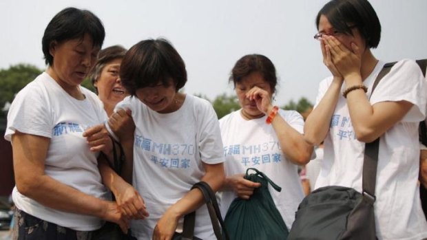 Relatives of  passengers aboard the missing jet gather at a Beijing temple on June 15 to mark the 100th day since the plane disappeared.