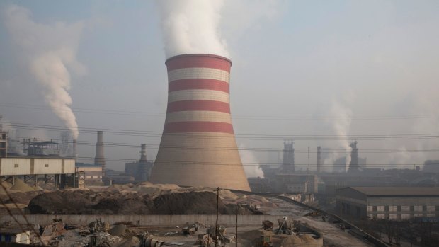 Smoke spews from the sprawling complex that is a part of the Jiujiang steel and rolling mills in Qianan in northern China's Hebei province. 