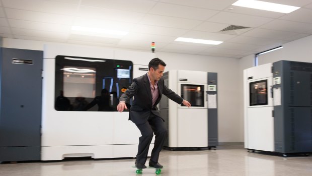 Objective3D CEO Matt Minio on a skate board printed on one of the machines in the background. 