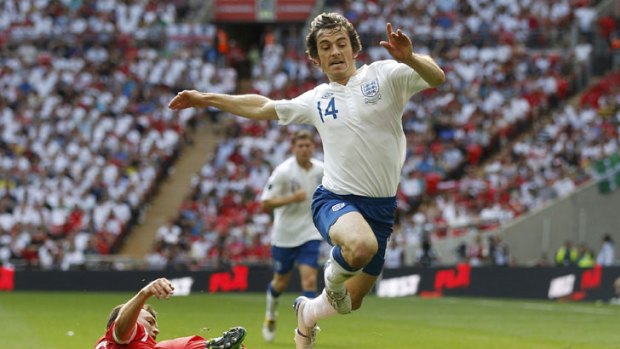 Slide show ... England's Leighton Baines is tackled at Wembley.