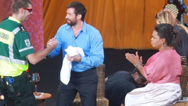 Actor Hugh Jackman gets some first aid after a stunt at the Sydney Opera House went wrong. 