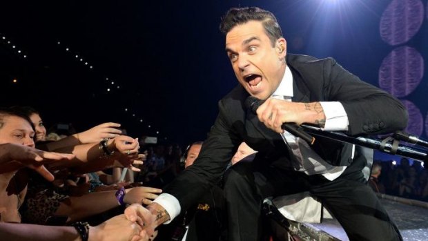 Swinging: Robbie Williams, putting on the Ritz, and then some. 