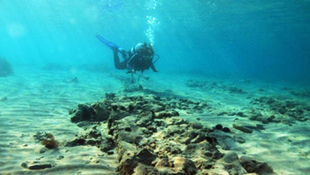 Planned town dating back about 5000 years  ... a diver explorers the sunken settlement.