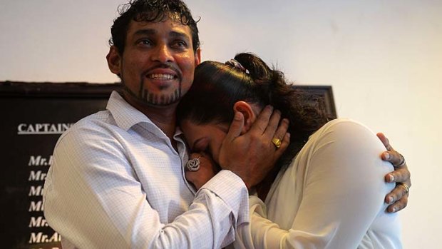 Tillakaratne Dilshan comforts his wife, Manjula Thilini, after she broke down when he announced his retirement from Test cricket in Colombo.