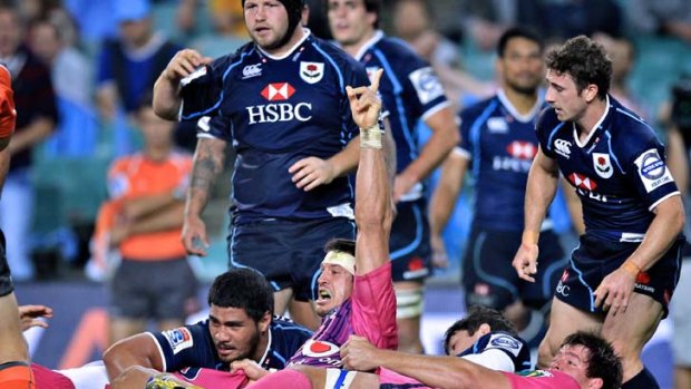 Sitting pretty in pink ... the Bulls score a late try to beat the Waratahs on Friday night. The defeat has left the season hanging by a thread for Michael Foley's side.