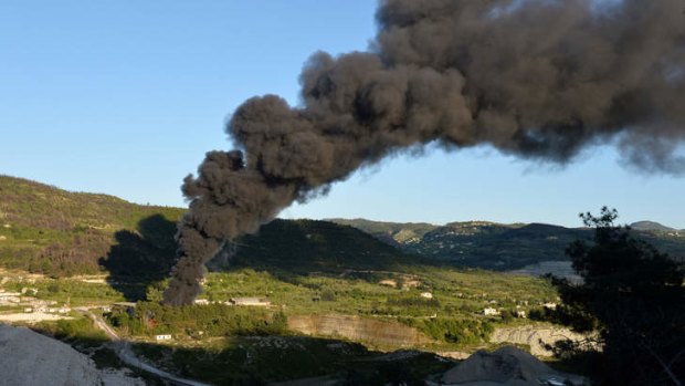 Alarm: Smoke rises after shelling on al-Turkman mountains in western Syria on Thursday.