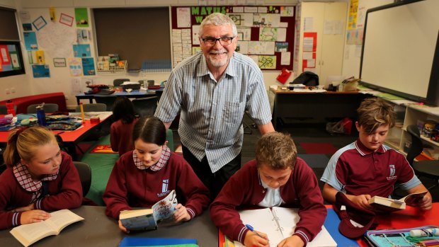 Switched: Michael Higgins, with some of his grade 5 students. The former engineer went into teaching at an age when some are considering retirement and loves the classroom. 