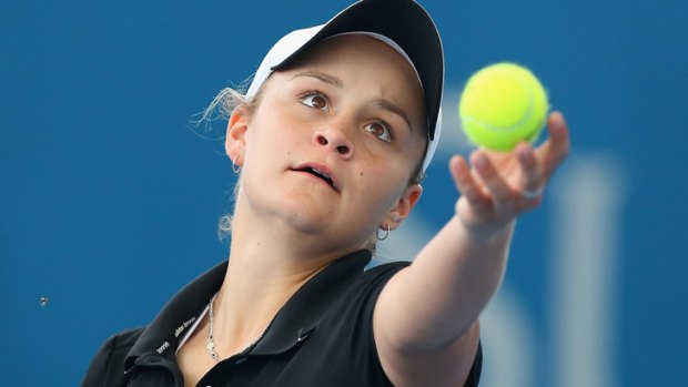 Ashleigh Barty of Australia serves in her doubles match partnered with Casey Dellacqua at the 2014 Brisbane International.