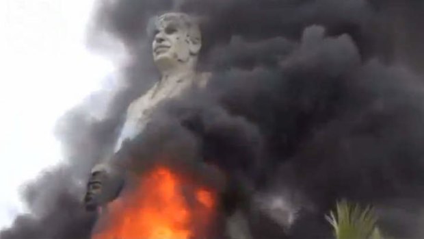 Regime defiant  ... A statue of Hafez Assad, father of Syrian President Bashar Assad, burns after being set on fire by rebel fighters inside the grounds of the General Company of the Euphrates Dam in Al-Raqqa.