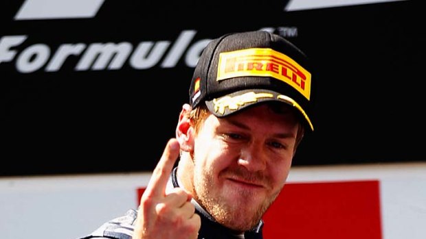 Sebastian Vettel is all smiles on the podium after winning his fourth Grand Prix for the year.