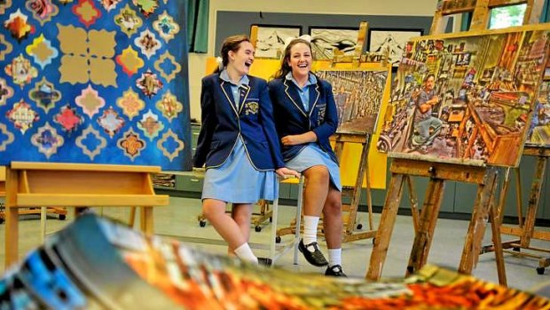 Top performers in VCE art Nese Gezer (left) and Camille Mance, from Loreto Mandeville Hall, with their works Panes and Men at Work.