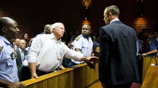 Pistorius' father, Henke, reaches out to his son in court.