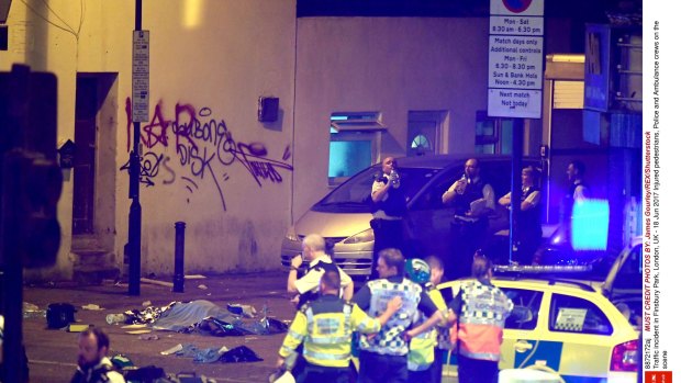 Police at the scene of the crash in Finsbury Park, north London, in which a van ploughed into a group of people.