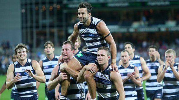 High times: Jimmy Bartel is chaired off by his teammates after putting in a typically classy performance in his 250th game.