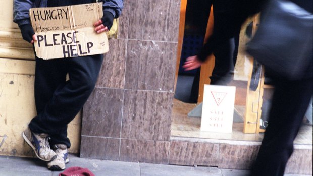 A man begs for money in Bourke Street.