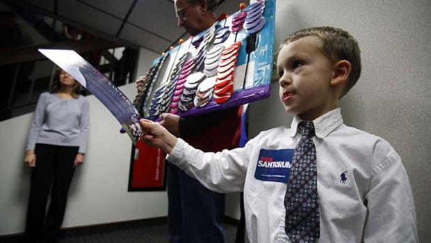 Four-year-old Austin Hall passes out Republican campaign brochures.