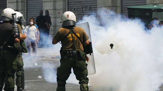 Tear gas ... demonstrators clash with police in Athens.
