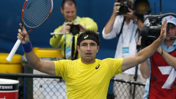 Rev-up: Marinko Matosevic tries to get the crowd involved after his second-round win over Andreas Seppi. 'Mad Dog' later said he was less than impressed by the tepid home support.