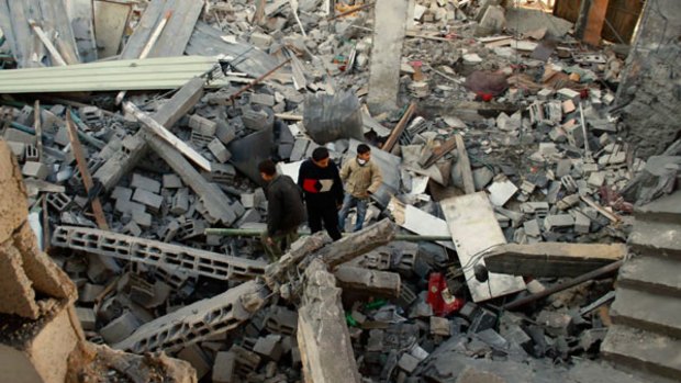 Palestinians inspect the rubble of a building destroyed by Israeli forces in Rafah refugee camp, southern Gaza.